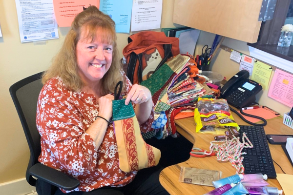 Volunteer – Administrative A woman works in the reception office on a special project for the holidays.