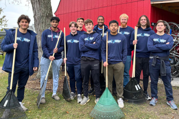 Volunteer – Group Projects A group of student volunteers from Northwood University participating in Go MAD Day rake up fall leaves at Midland's Open Door.