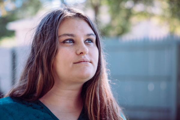 A female outreach guest at Midland's Open Door looks upward, signifying hope for the future.